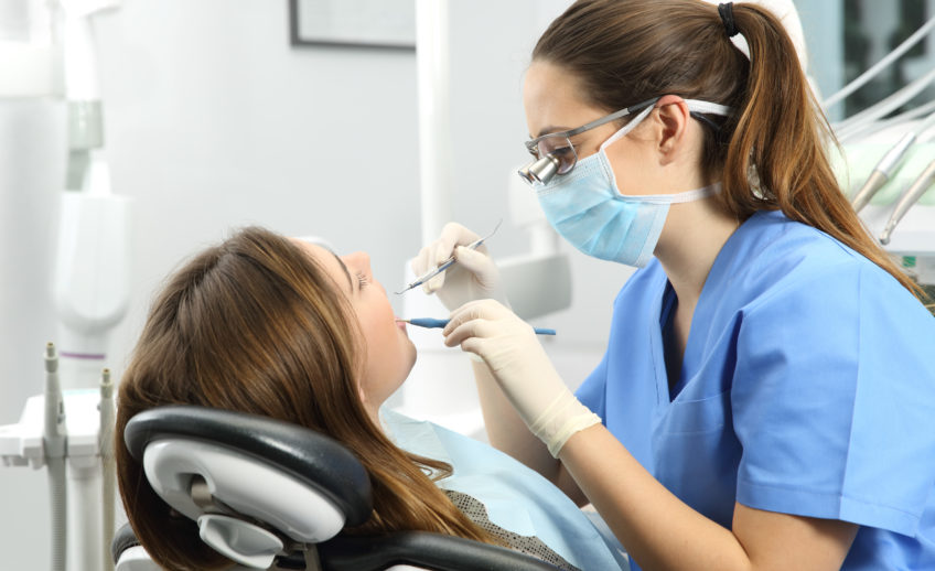 Dentist examining a patient teeth
